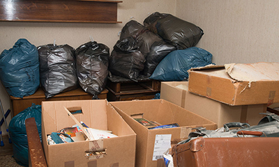 Boxes and bags of rubbish piled up indoors